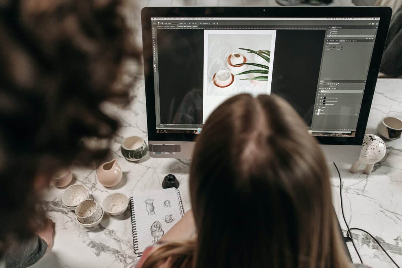 a girl working on photoshop on a desktop working for a business idea picture